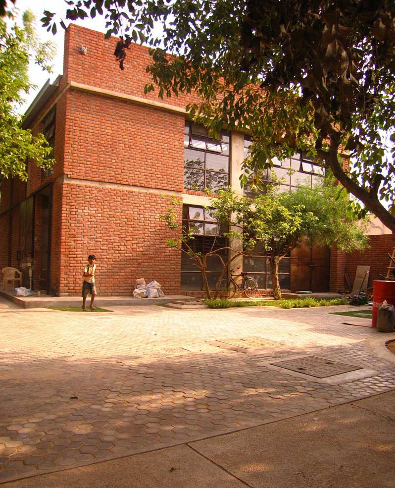 The road from the entrance widens into small court which houses the core services and ancillary spaces.