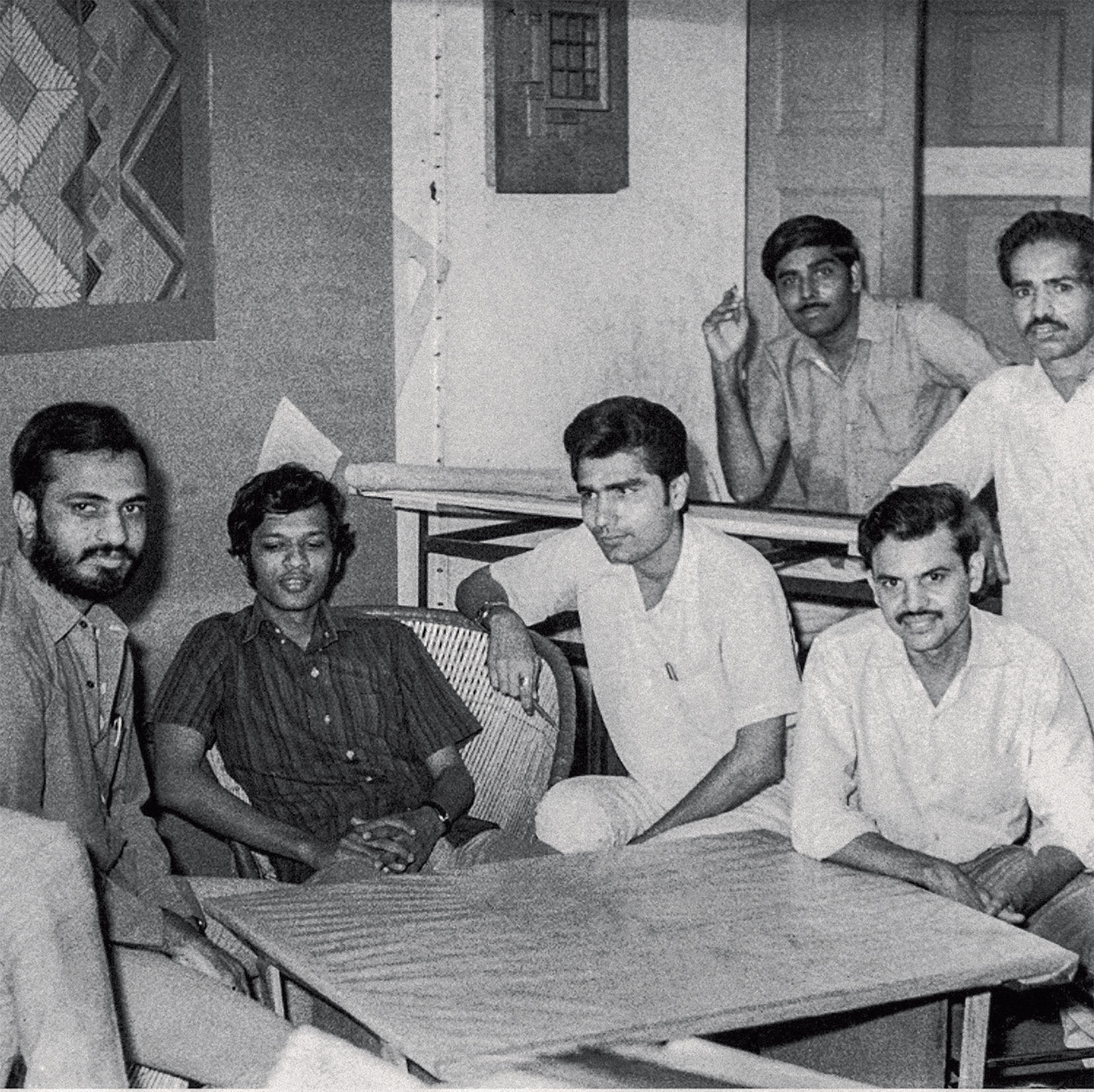 Architects in Hasmukh Patel's office in the mid 1960's when his office was located in Astodia, Ahmedabad. From the left: Navin Patel, Leo Pereira, S.Mashruwala, R.Desai, Kulin Dave, and model maker Balubhai Mistry